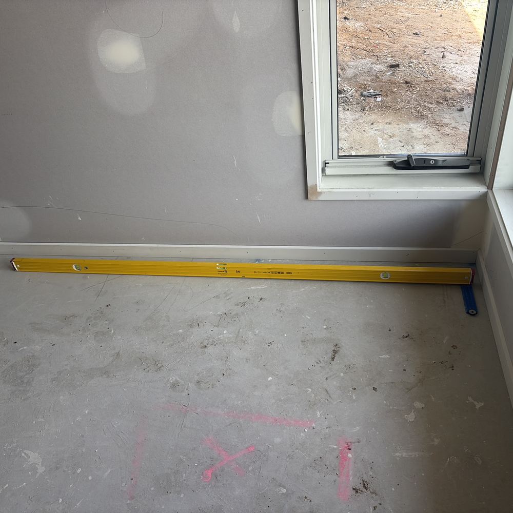 Floor slab out of level by more than the allowed deviation, found during a fixing inspection in Sunbury