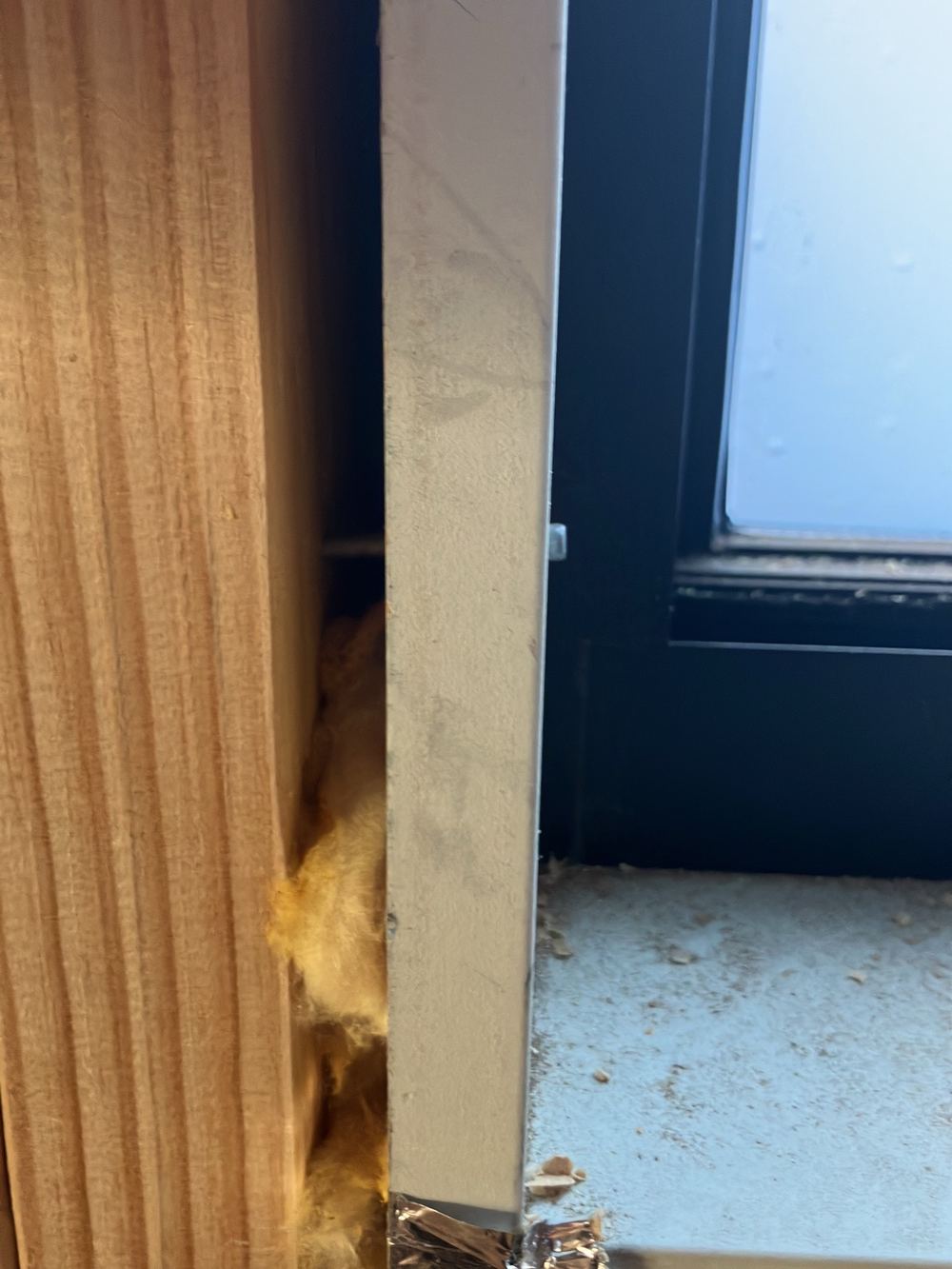Window not fully installed, with packers missing at the frame, found during a lock-up inspection in Sunbury