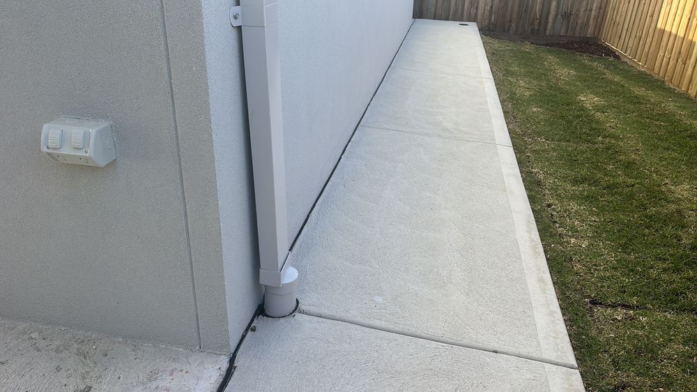 Cladding finishing less than 75mm above the concrete path, found during a pre-handover inspection in Sunbury