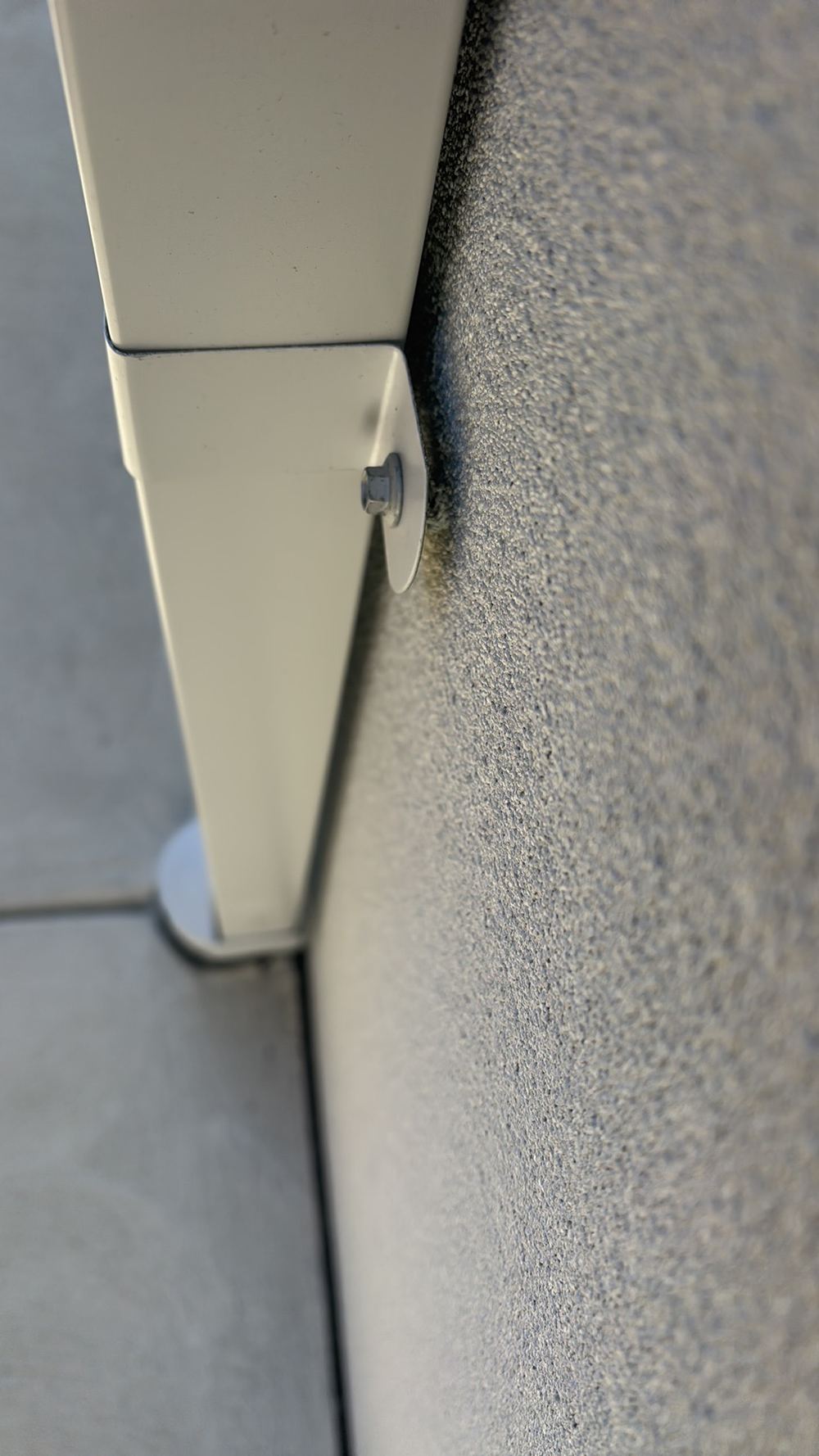 Downpipe left unsecured against the rendered wall, Sunbury