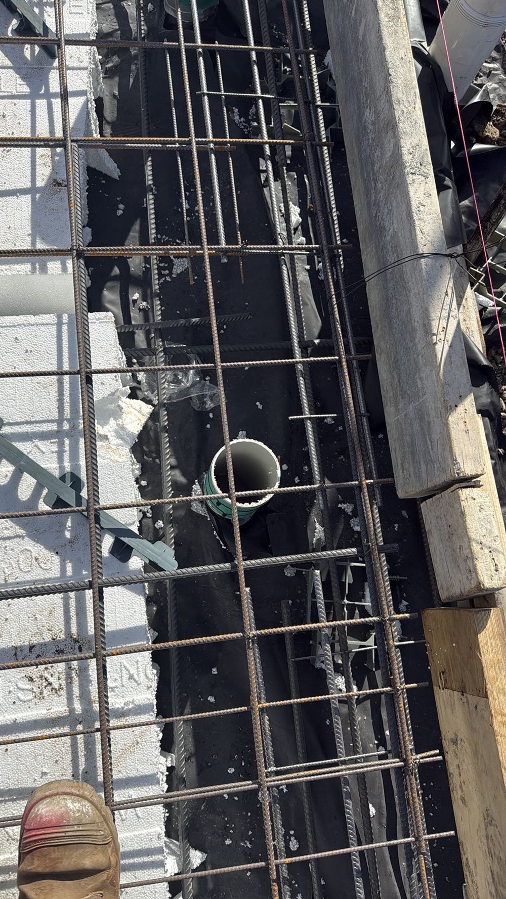 Slab mesh resting against service pipes where a 25mm gap is required, found during a slab pre-pour inspection in Sunbury