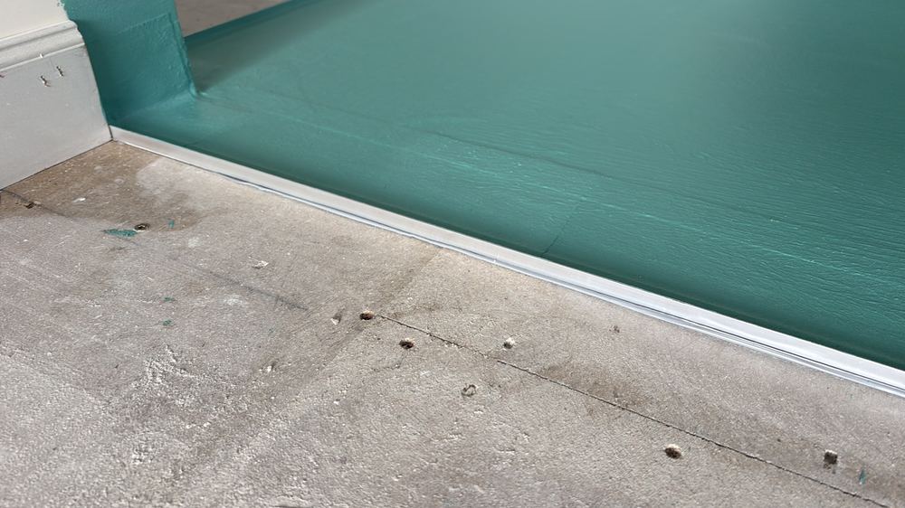 Membrane laid straight onto timber flooring, an unsuitable base, found during a waterproofing inspection in Reservoir